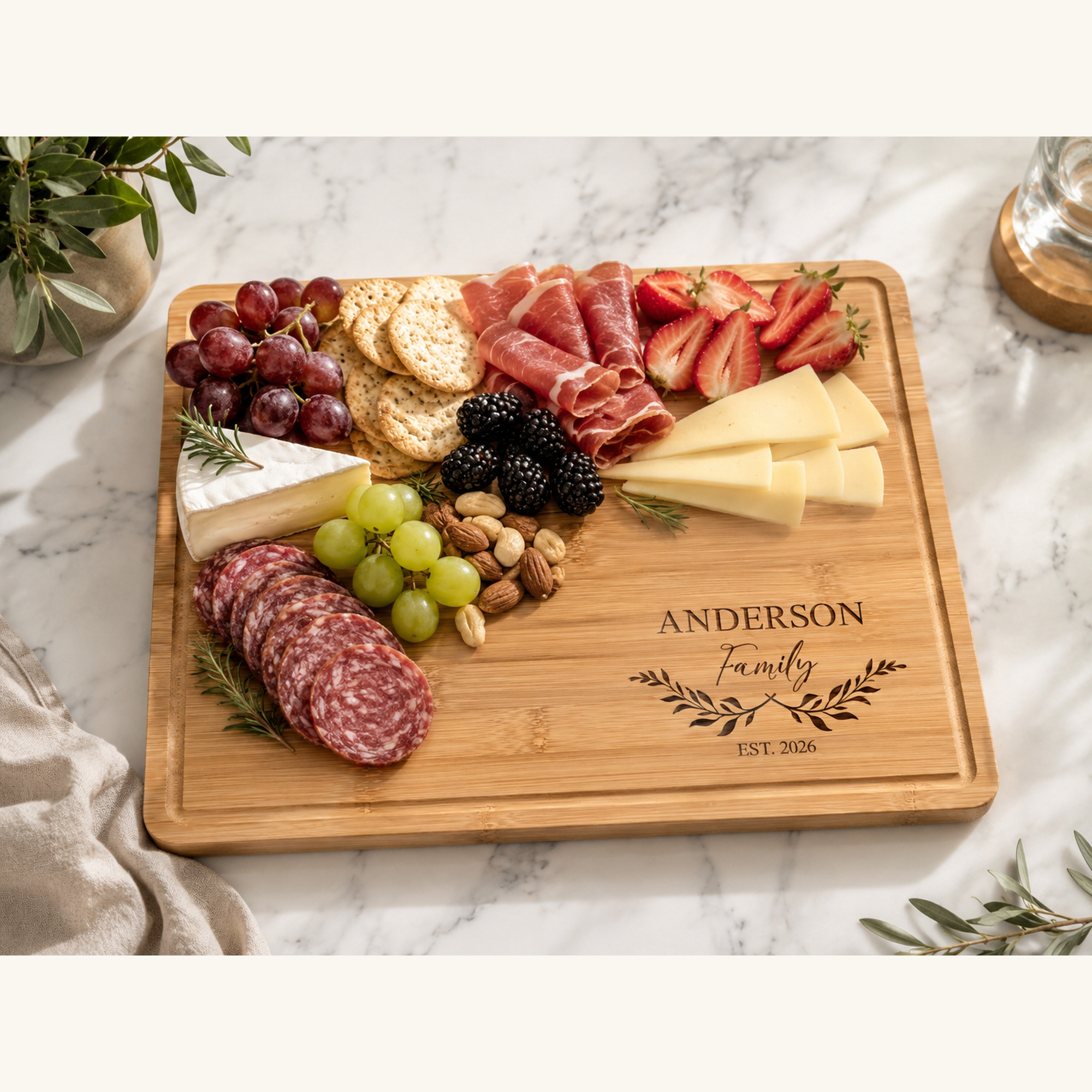 Personalized bamboo charcuterie board styled with cheese, fruit, and meats